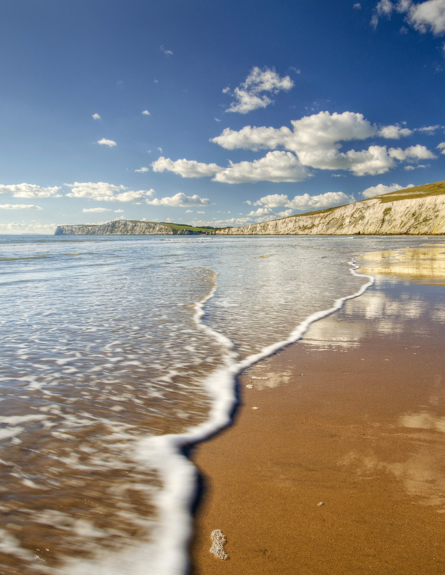 The sandy beach at Compton Bay on the Isle of Wight, with the white chalk cliffs beyond